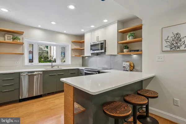 a kitchen with a table and chairs in it