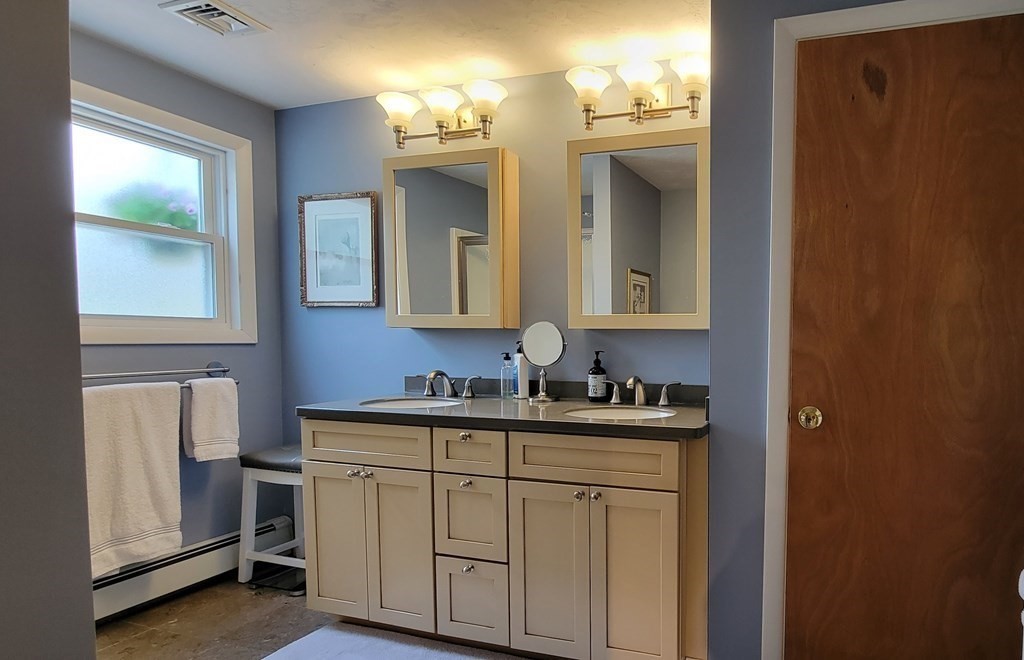 185 Evelyn Road Needham, MA 02494 - Photo 11 of 23 a bathroom with a sink and a mirror
