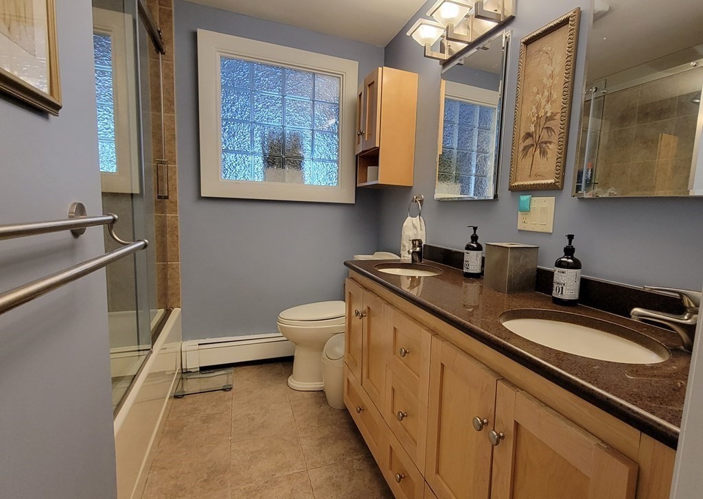 185 Evelyn Road Needham, MA 02494 - Photo 13 of 23 a bathroom with a granite countertop toilet sink and mirror