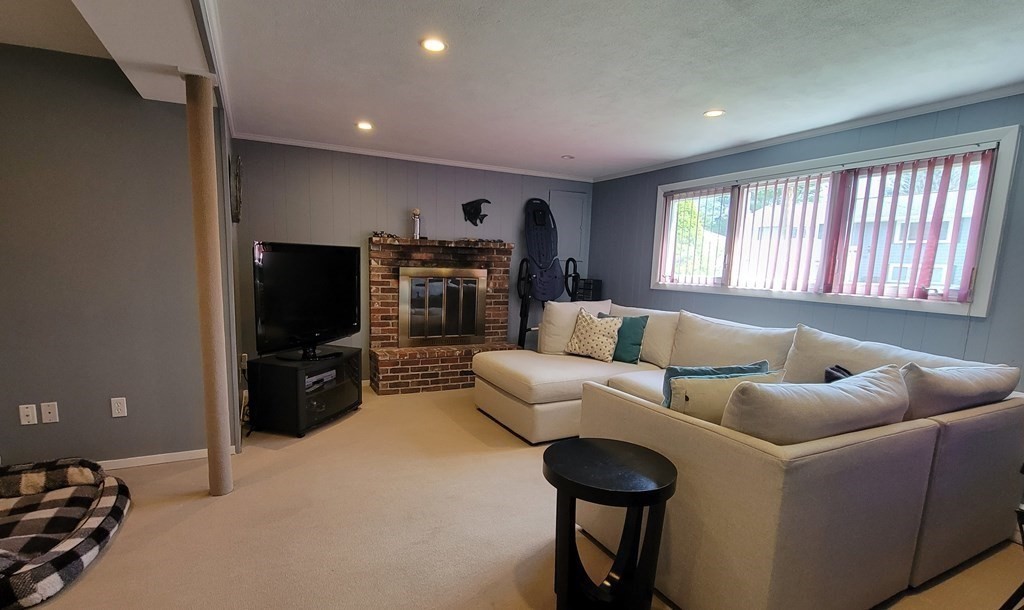 185 Evelyn Road Needham, MA 02494 - Photo 17 of 23 a living room with furniture and a flat screen tv
