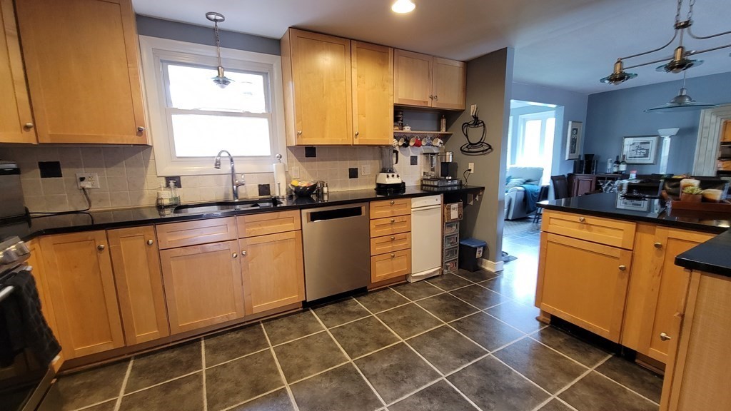 185 Evelyn Road Needham, MA 02494 - Photo 2 of 23 a kitchen with stainless steel appliances a sink stove refrigerator and cabinets
