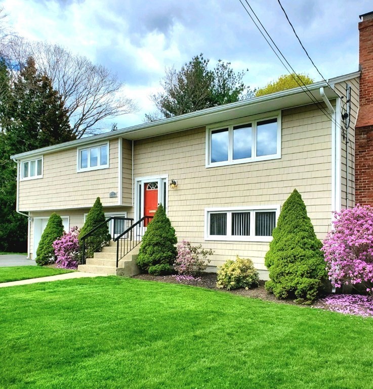 185 Evelyn Road Needham, MA 02494 - Photo 21 of 23 a front view of a house with a yard and potted plants