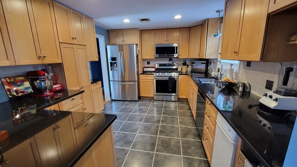 185 Evelyn Road Needham, MA 02494 - Photo 3 of 23 a kitchen with stainless steel appliances a refrigerator sink stove microwave and cabinets