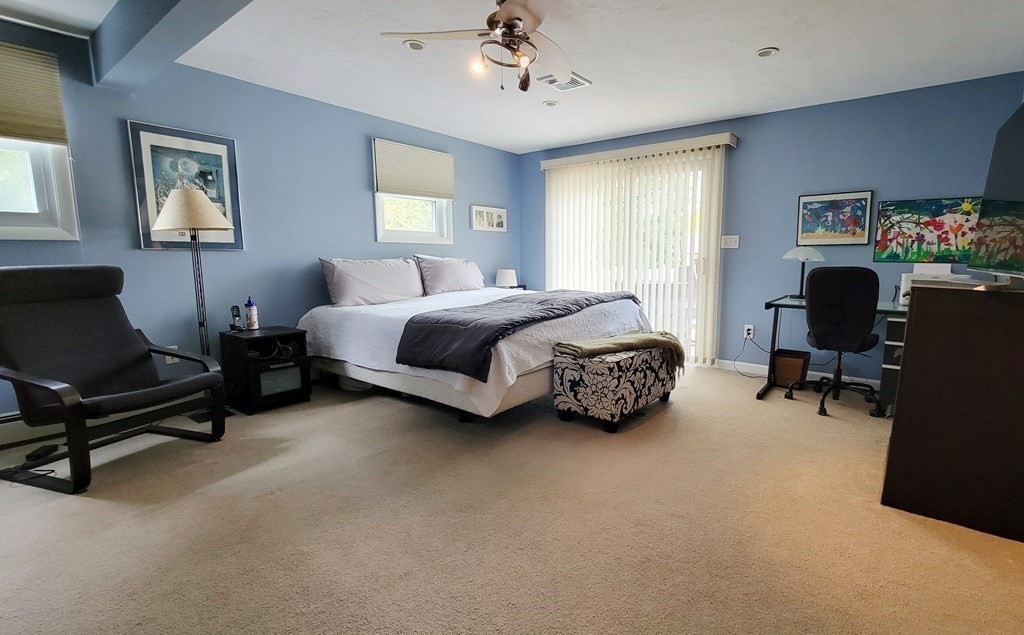 185 Evelyn Road Needham, MA 02494 - Photo 10 of 23 a spacious bedroom with a bed a couch and a window
