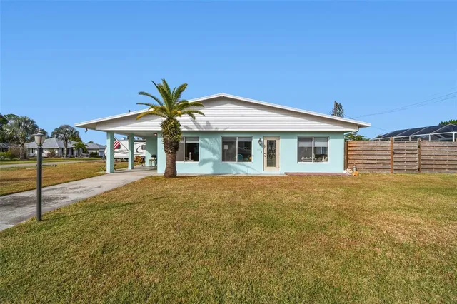 a view of house with yard and outdoor seating