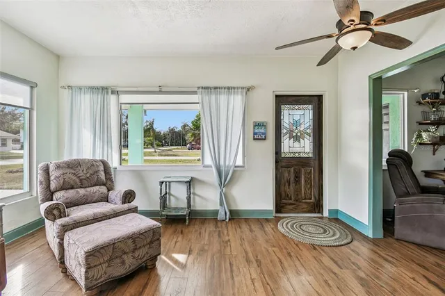 a living room with furniture and a wooden floor