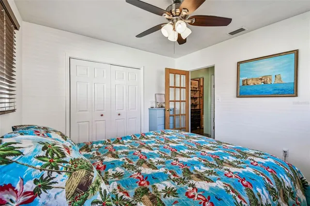 a bedroom with bed and paintings on wall