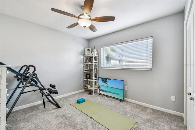 a room with gym equipment and a view of living room