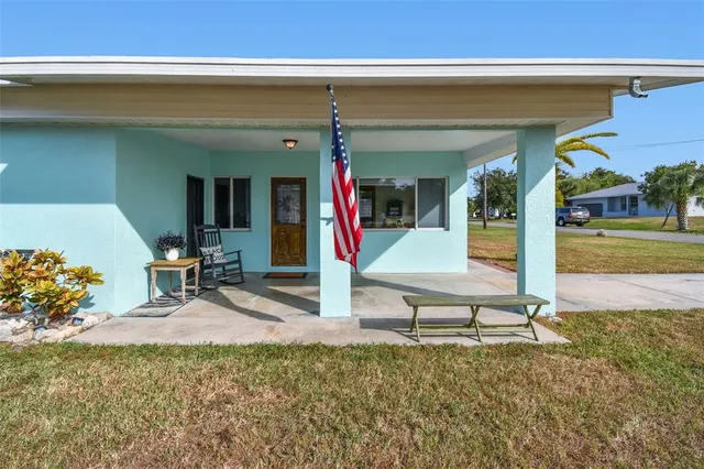 a view of a house with a porch and sitting area