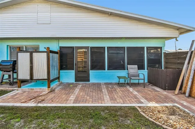 a backyard of a house with table and chairs