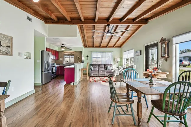 a dining room with furniture and wooden floor