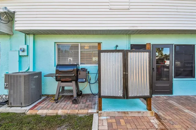 an aerial view of a house with swimming pool and a yard