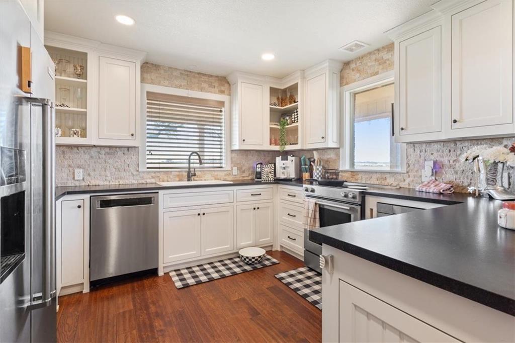 347 Howe Hill Road Lorena, TX 76655 - Photo 11 of 38 a kitchen with stainless steel appliances granite countertop a sink dishwasher stove and refrigerator
