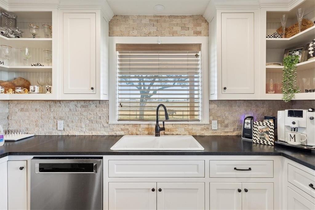 347 Howe Hill Road Lorena, TX 76655 - Photo 12 of 38 a kitchen with white cabinets and a window