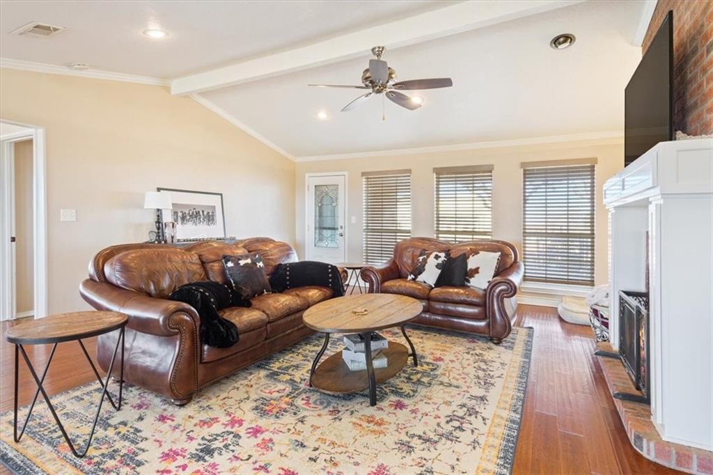 347 Howe Hill Road Lorena, TX 76655 - Photo 5 of 38 a living room with furniture a fireplace and a flat screen tv