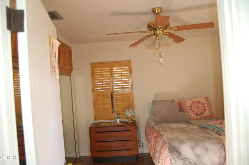 3912 Mohawk Street Pasadena, CA 91107 - Photo 11 of 24 a bedroom with a bed and a chandelier