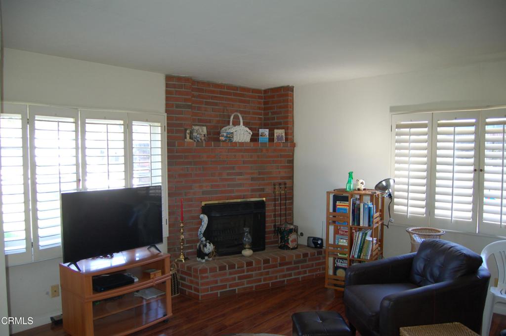 3912 Mohawk Street Pasadena, CA 91107 - Photo 4 of 24 a living room with furniture a flat screen tv and a fireplace