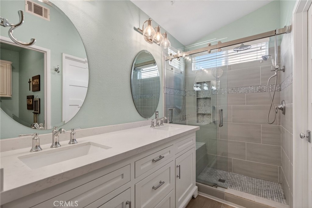 19584 Jill Court Riverside, CA 92508 - Photo 15 of 31 a bathroom with a double vanity sink mirror and shower