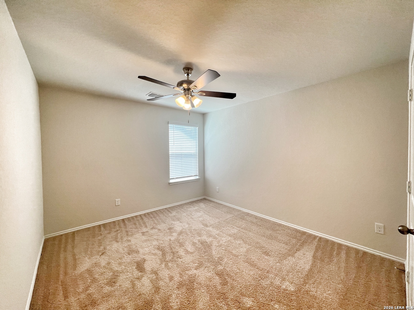 29529 Spring Copper Bulverde, TX 78163 - Photo 28 of 41 an empty room with a chandelier fan and windows