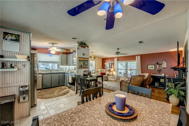a kitchen with a table chairs stove and refrigerator