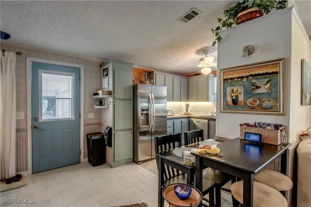 a kitchen with granite countertop a refrigerator and a sink