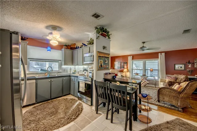a kitchen with stainless steel appliances a sink cabinets and wooden floor
