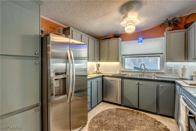 a kitchen with stainless steel appliances a stove sink and cabinets