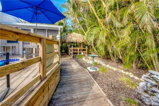 a view of a patio with table and chairs under an umbrella