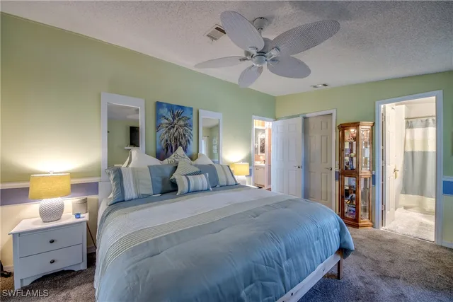 a bedroom with a bed a couch and dresser