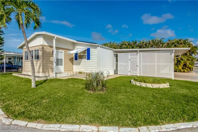 a view of a house with a backyard