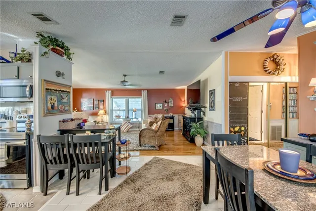 a view of a a dining room with furniture window and wooden floor