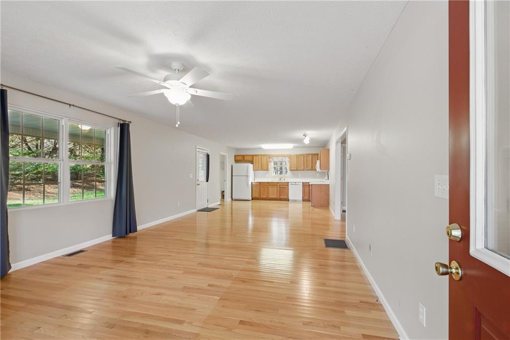 218 Eden Woods Clarkesville, GA 30523 - Photo 3 of 35 a view of empty room with wooden floor and fan