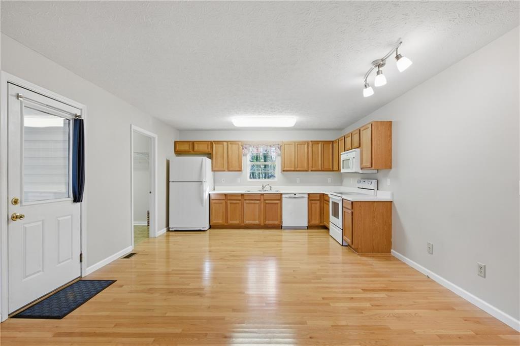 218 Eden Woods Clarkesville, GA 30523 - Photo 5 of 35 a view of a kitchen with kitchen island wooden floor and window