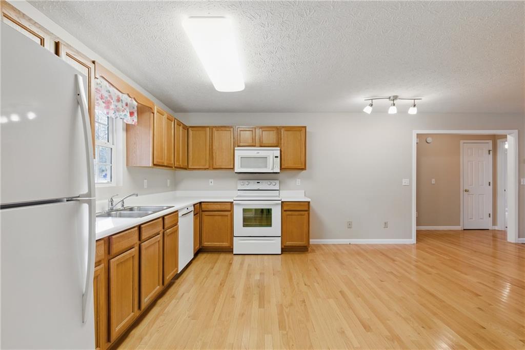 218 Eden Woods Clarkesville, GA 30523 - Photo 6 of 35 a kitchen with stainless steel appliances granite countertop a stove and a sink