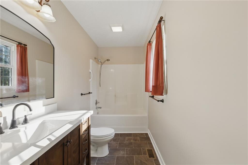 218 Eden Woods Clarkesville, GA 30523 - Photo 10 of 35 a bathroom with a sink a toilet and shower