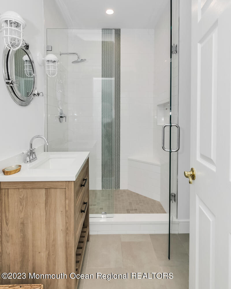 306 Ocean Road Spring Lake, NJ 07762 - Photo 13 of 45 a bathroom with a sink a toilet and a shower