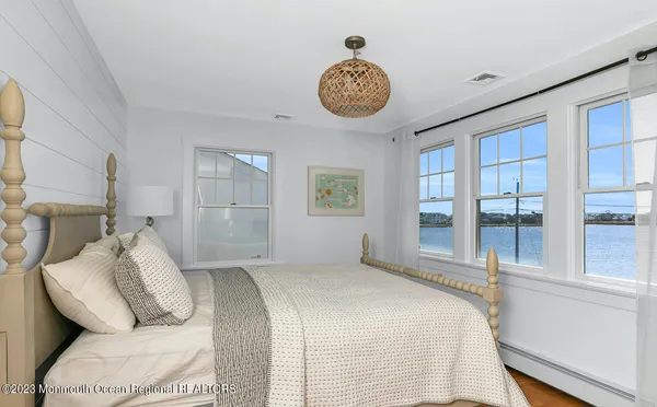 a bedroom with a bed and a painting on the wall