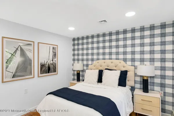 a bedroom with two beds and a couch