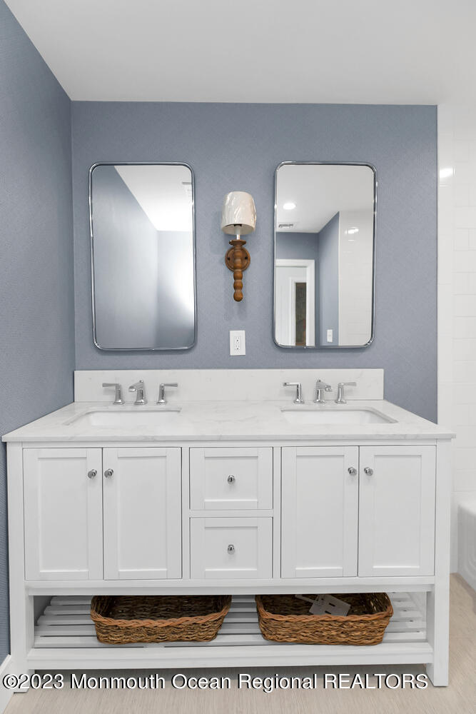 306 Ocean Road Spring Lake, NJ 07762 - Photo 22 of 45 a bathroom with a sink a mirror and vanity