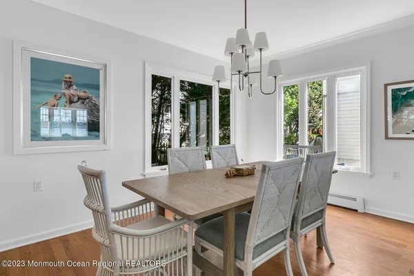 a kitchen with stainless steel appliances granite countertop a stove a sink a dining table and chairs