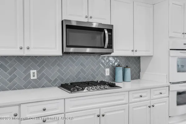 a kitchen with a sink a stove and a window