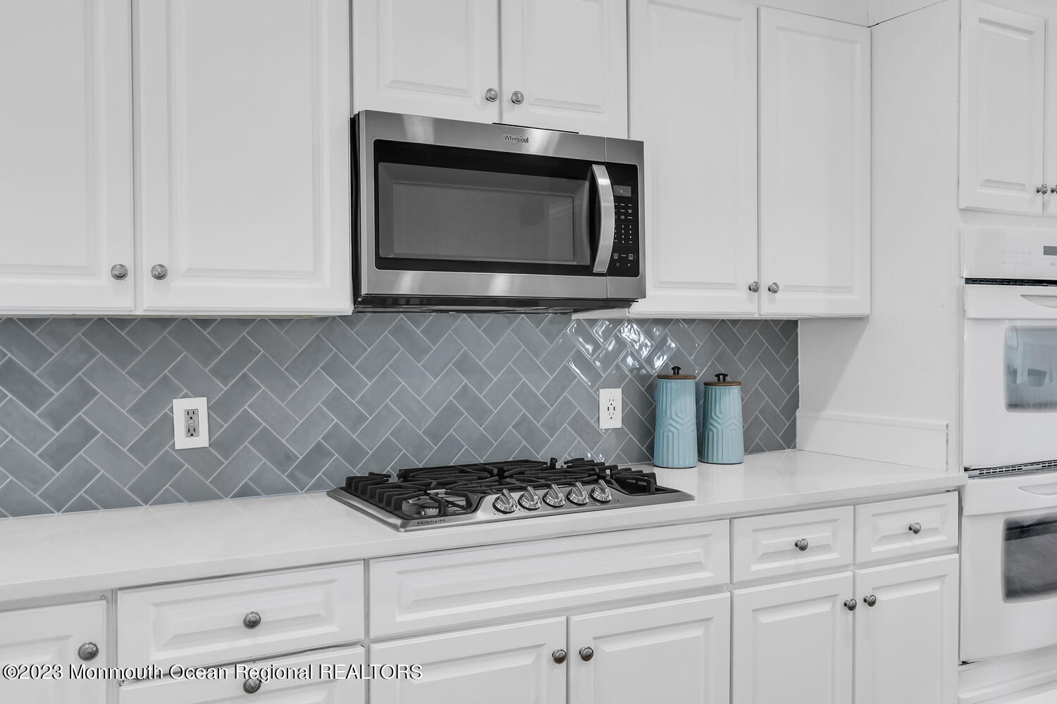 306 Ocean Road Spring Lake, NJ 07762 - Photo 27 of 45 a kitchen with white cabinets and appliances