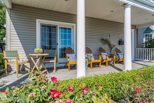 a view of a patio with table and chairs and wooden floor