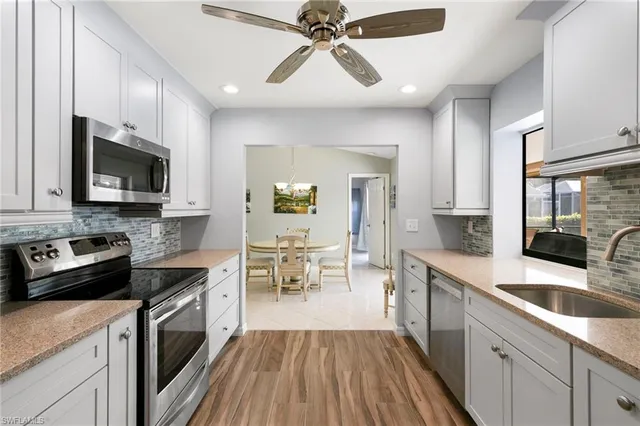 a kitchen with a sink stove and microwave