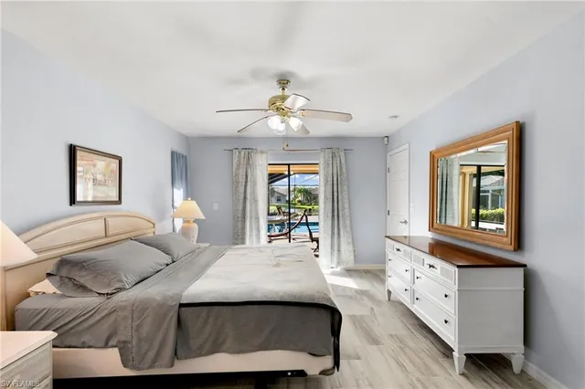 a bedroom with a bed chandelier and a window