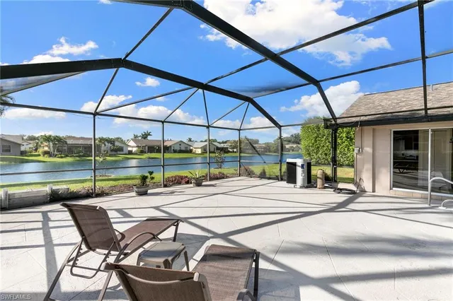 a view of a patio with a table and chairs under an umbrella