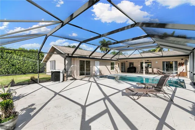 a view of a patio with table and chairs under an umbrella
