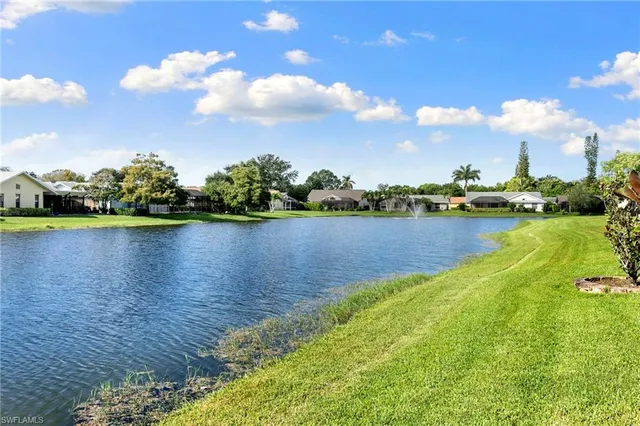 a view of a lake with houses in the back