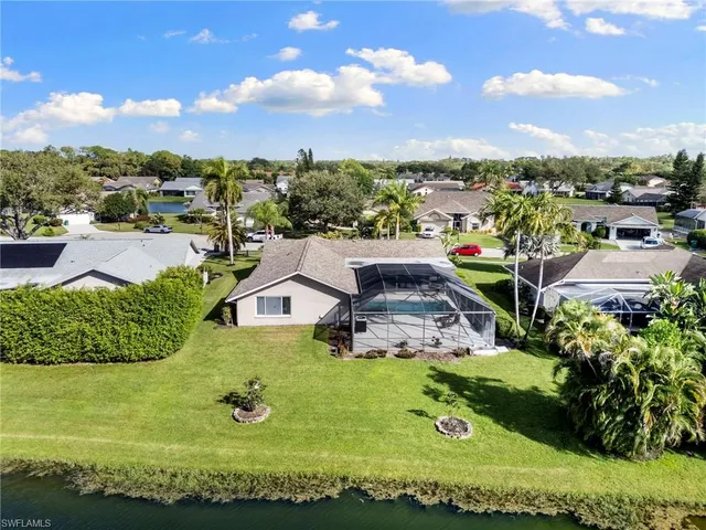 a view of a swimming pool with an outdoor seating and lake view