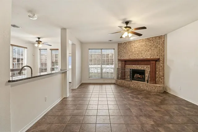 a view of a kitchen with a sink and a fireplace